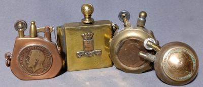three different types of antique brass items on a blue surface