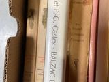 many books in a cardboard box on a table