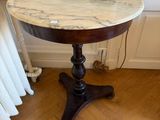 a marble top table with a lamp on top of it