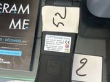 a cell phone sitting on top of a table next to a book