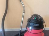 a vacuum that is sitting on the floor next to a vacuum
