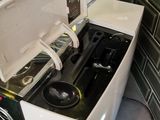 a washing machine that is sitting in the corner of a room