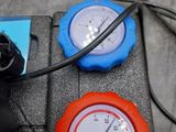 two gauges on the back of a car with wires