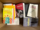 books in a cardboard box are stacked on top of each other