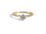 an image of a gold ring with a white diamond