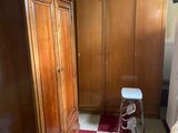 an image of a bedroom with a closet and a chair