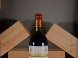 a bottle of wine sitting on a table next to wooden blocks