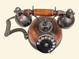 an old fashioned telephone with a wooden handle
