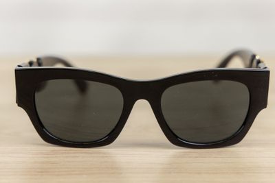 a close up of a pair of black sunglasses on a table