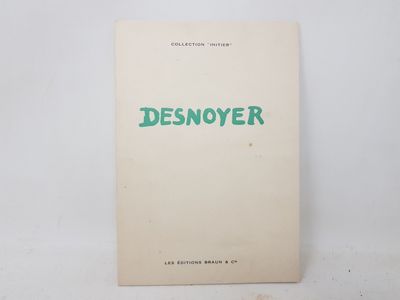 a white book with green writing on it sitting on top of a table