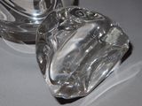 a clear glass container sitting on a table next to a glass container