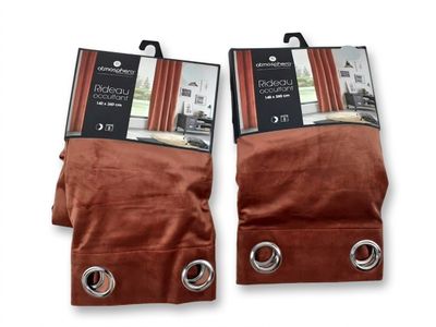 two pairs of brown curtains with metal rings on them
