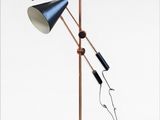 two lamps on a stand with a cord connected to them