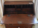 a wooden desk with a drawer on top of it