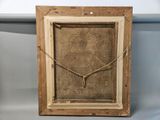 a close up of a picture of a wooden frame on a table