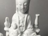 chinese porcelain figurine of a woman holding a baby and three children