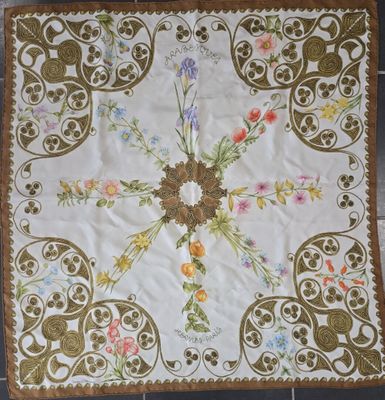 a white and brown table cloth with flowers on it