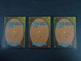 three decks of magic the gathering cards are sitting on a table