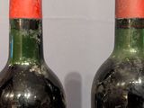 two bottles of wine that are sitting on a table