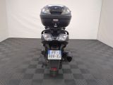 a motorcycle that is parked in a room with a checkered floor