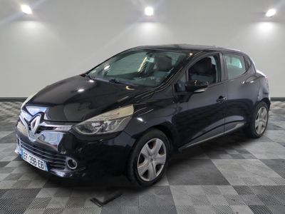 the black car is parked on a checkered floor in the garage