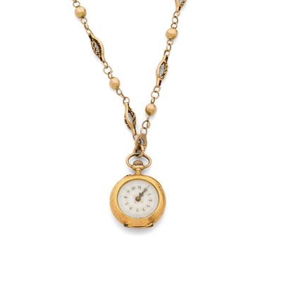 a close up of a gold necklace with a clock on it