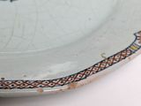 a white plate with a blue and red design on it