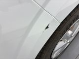a close up of a tire on a white car