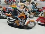 many figurines of people riding motorcycles on display