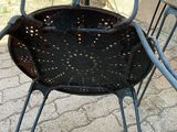 a black chair that is sitting on a brick patio