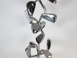 a metal sculpture of golf clubs on a stand