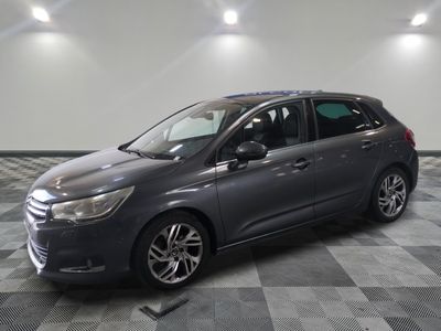a picture of a grey car parked in a garage