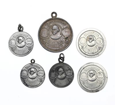 six silver medal medals with a picture of a woman and a child on them