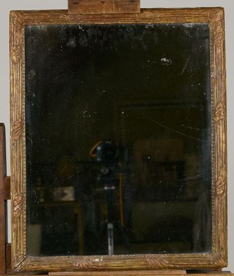 a mirror sitting on top of a wooden table