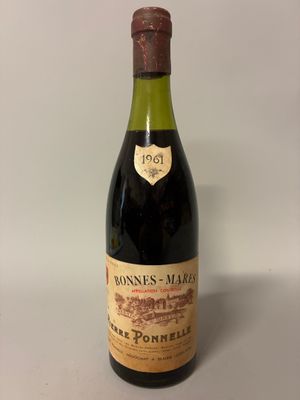 an old bottle of wine sitting on a table