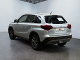 the rear end of a silver suv parked in a garage