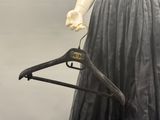 a mannequin with a dress hanger attached to it