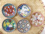 several plates are arranged on top of a bamboo tray