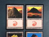 four cards with different images of mountains on them on a table