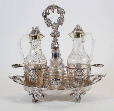 a silver plate with two glass bottles and a silver tray
