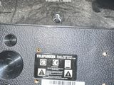 a close up of a black camera with a yellow sticker on it
