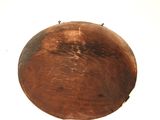 a brown object on a white surface that looks like a bowl