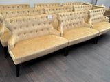 a row of couches in a room with wood flooring