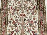 an antique persian rug with a tree of life on it