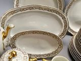many different types of porcelain dishes and cups on the table