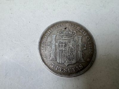 a close up of a coin on a table with a white background
