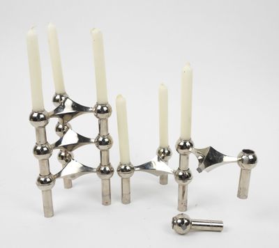 silver metal candle holders with white candles on a white background