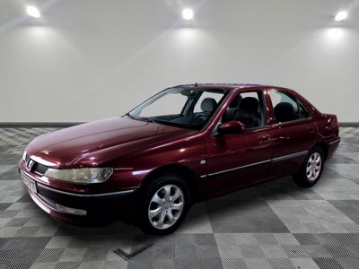 an image of a maroon car parked in a garage