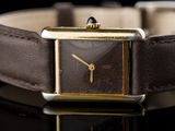 a close up of a watch on a black surface