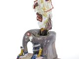 a figurine of an elephant and a man sitting on top of it